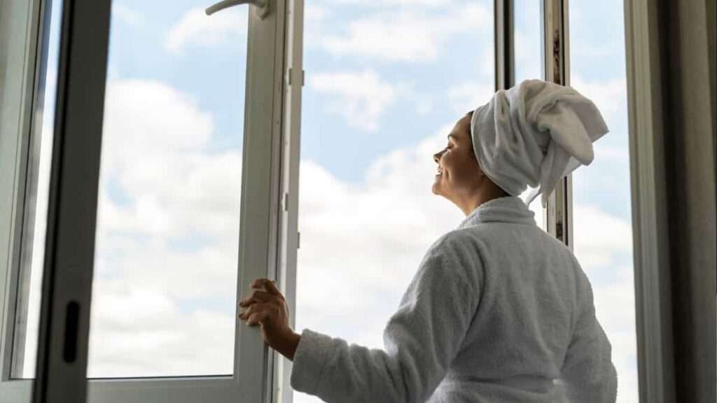 Women enjoying fresh air from uPVC windows