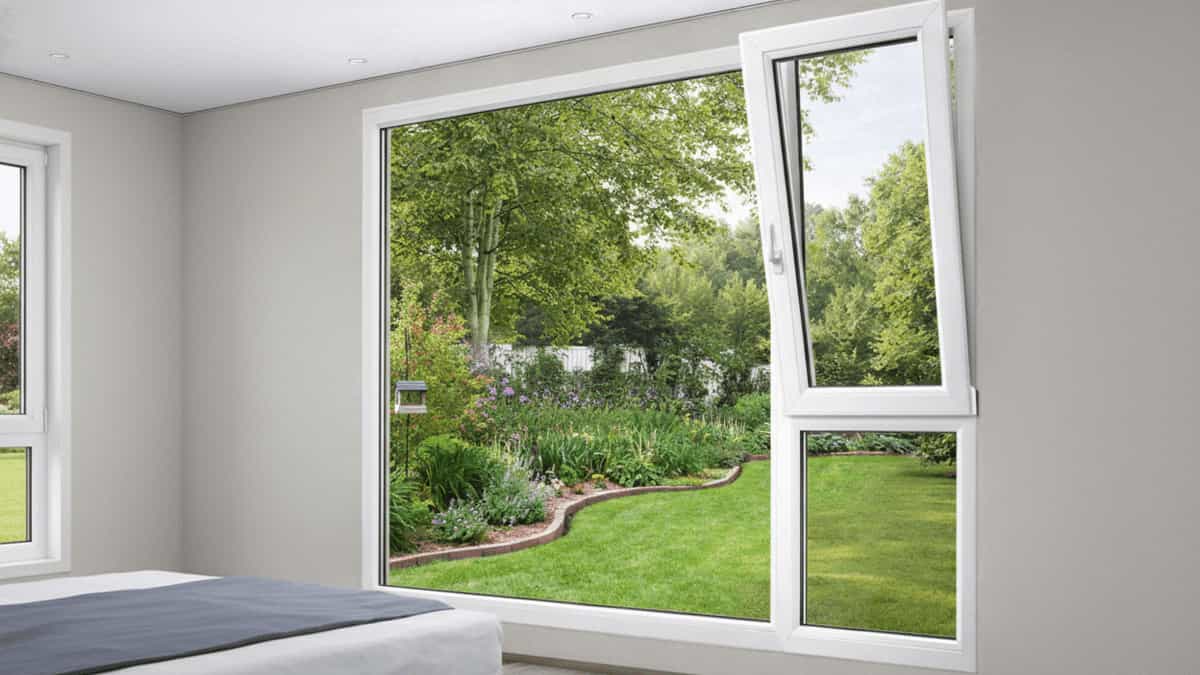 Large uPVC fixed glass window featuring a massive viewing panel alongside a side casement opening for ventilation in a modern bedroom overlooking a garden.