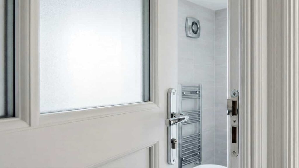 White uPVC bathroom door featuring a sandblasted frosted glass panel to balance light flow and privacy.