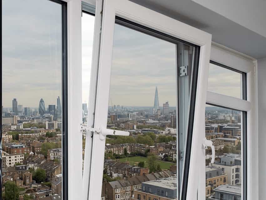 uPVC Double Glazed Windows Options White uPVC tilt and turn window in tilt mode overlooking a city skyline